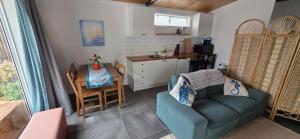 a living room with a couch and a table and a kitchen at Studio in Quindalup bay in Quindalup