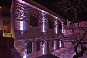a building with lights on it at night at My Cave La Maison Du Reve in Uchisar