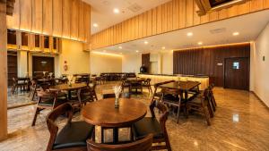 a restaurant with tables and chairs and a bar at Wyndham Garden Durango in Durango +17 photos