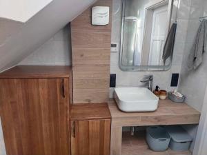 a bathroom with a sink and a mirror at Dom za wydmą in Nielbark +100 photos