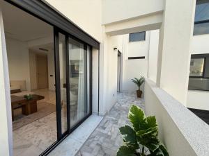 a hallway of a house with glass doors and plants at Living Fleuri Suites & Studios in Casablanca