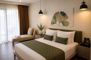 a hotel room with a bed and a chair at Bluezone Club Residences by A'ila Resorts in Rodney Bay Village +54 photos