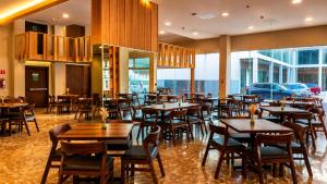 a restaurant with wooden tables and chairs in a room at Wyndham Garden Durango in Durango