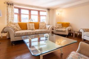 a living room with a couch and a table at Abbey Farm House - Pet Friendly in Ormskirk