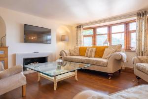 a living room with a couch and a table at Abbey Farm House - Pet Friendly in Ormskirk