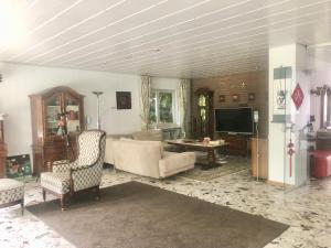a living room with a couch and a tv at Only Lady Kaarst in Kaarst +10 photos