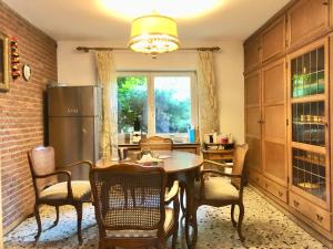 a kitchen with a table and chairs and a refrigerator at Only Lady Kaarst in Kaarst