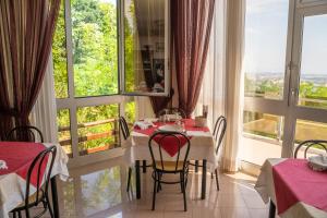 a dining room with a table and a large window at Albergo Centopini in Gemmano