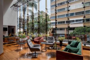 a lobby with chairs and tables and a building at Crowne Plaza Lima - Miraflores by IHG in Lima