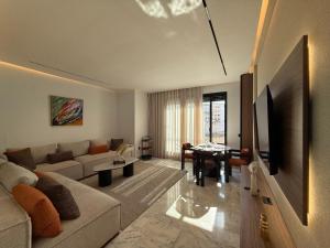 a living room with a couch and a table at Living Fleuri Suites & Studios in Casablanca