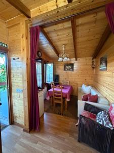 a log cabin living room with a couch and a table at Apartamento El Paso in Fuentelisendo