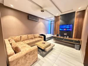 a living room with a couch and a bed at The Horizon Hotel Islamabad in Islamabad +12 photos