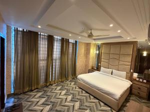 a bedroom with a bed in a room with windows at The Horizon Hotel Islamabad in Islamabad