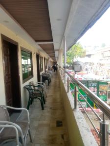 a corridor of a building with chairs and tables at Hotel Marhaba in in Murree