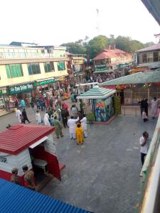 a crowd of people walking around a market with stalls at Hotel Marhaba in in Murree