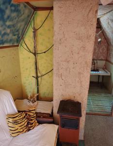 a room with a stove and a bed in a room at Chata u Emi a Ivana in Tajov