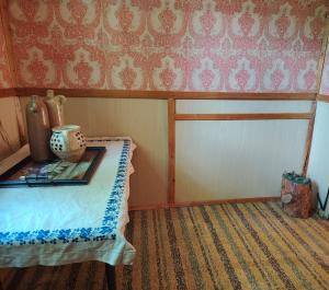 a room with a table with a vase on it at Chata u Emi a Ivana in Tajov