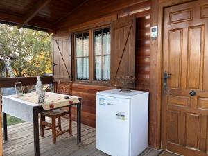 a kitchen with a refrigerator and a table on a porch at Apartamento El Paso in Fuentelisendo