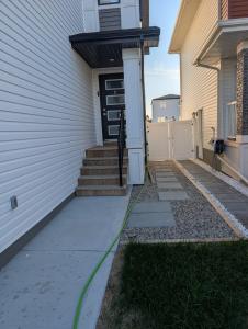 a front door of a house with a green hose at Olas Place in Regina