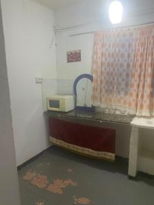 a kitchen with a counter with a microwave on it at Hôtel Dar Massmoudi in Tunis
