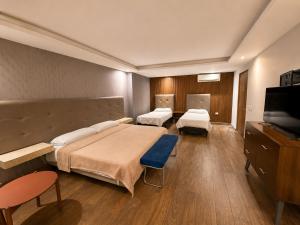 a hospital room with two beds and a flat screen tv at hotel 202 in Monterrey
