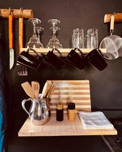 a wooden cutting board with utensils on a shelf at Casa Atelier AXM in Salento