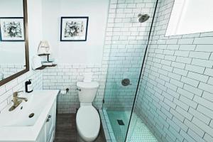 a bathroom with a toilet and a sink and a shower at Casa Morada in Islamorada
