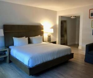 a bedroom with a large white bed and a couch at Casa Morada in Islamorada +68 photos