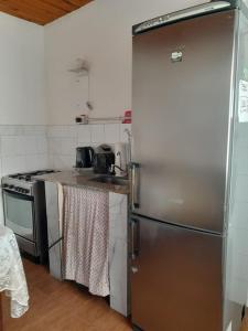 a kitchen with a stainless steel refrigerator and a stove at Villarrica in Valle Hermoso