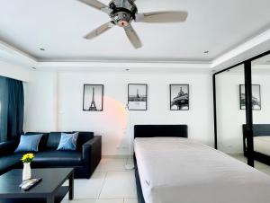 a living room with a bed and a ceiling fan at Beautiful Sea View Cozy Condo in Pattaya South +41 photos