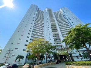 two tall white buildings with trees in front of them at Beautiful Sea View Cozy Condo in Pattaya South