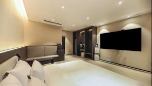 a large living room with a flat screen tv at Hotel RIL in Gwangju +15 photos