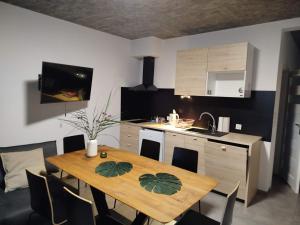 a kitchen with a wooden table and a dining room at Villa Antonina Apartamenty z aneksem in Czaplinek