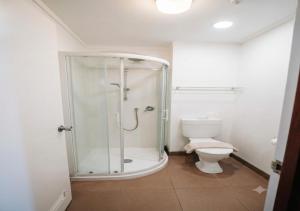 a bathroom with a shower and a toilet at The Grand Wanganui in Whanganui