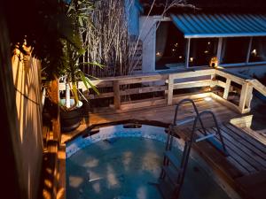 a hot tub on the deck of a house at night at Villa Sainte Anne in Sénas