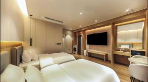a living room with a couch and a television at Hotel RIL in Gwangju