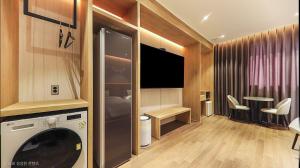 a living room with a washing machine in a room at Hotel RIL in Gwangju