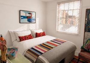 a bedroom with a bed and a couch and a window at Copeland House 4 Island Wall in Whitstable
