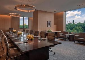 a conference room with a long table and chairs at Marco Polo Wuhan in Wuhan +94 photos