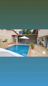 a villa with a swimming pool and a house at Maktub Estadia e recepções in Paulista