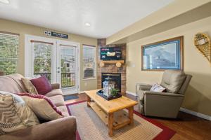 a living room with a couch and a fireplace at Basin Lakeside Getaway MH702Near Powder Mtn Hot Tub in Eden