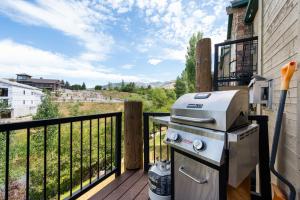 a grill on the balcony of a house at Basin Lakeside Getaway MH702Near Powder Mtn Hot Tub in Eden