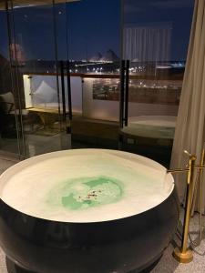 a jacuzzi tub with green water in a room at Sultan Pyramids Boutique Hotel View in ‘Ezbet `Abd el-Ḥamîd +94 photos