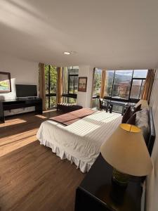 a bedroom with a bed and a large window at Hotel NASS Pinar del Lago in Cuenca +40 photos