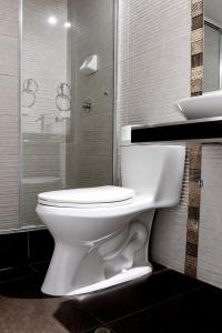 a bathroom with a white toilet and a sink at Hotel Inkayacu in Paracas +18 photos
