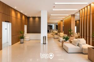 a lobby with couches and chairs in a building at Studio com Garagem e Acessibilidade | Granja Viana in Taboão da Serra +12 photos
