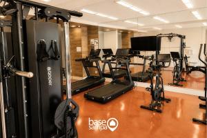 a gym with a bunch of treadmills and exercise bikes at Studio com Garagem e Acessibilidade | Granja Viana in Taboão da Serra