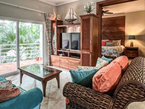 a living room with a couch and a tv at Ocean One - Harmony! in Cabarete