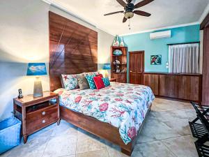 a bedroom with a large bed and a night stand at Ocean One - Harmony! in Cabarete +55 photos