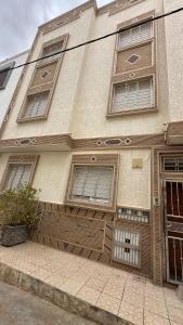 a building with windows on the side of it at Appartement Agadir T2 pour couples maries et familles in Agadir